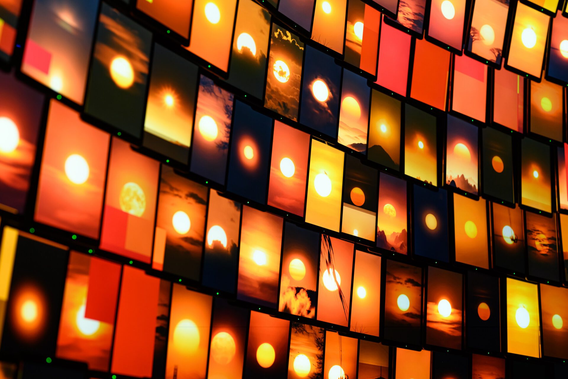 Close view of the individual screens showing warm orange and yellow light.